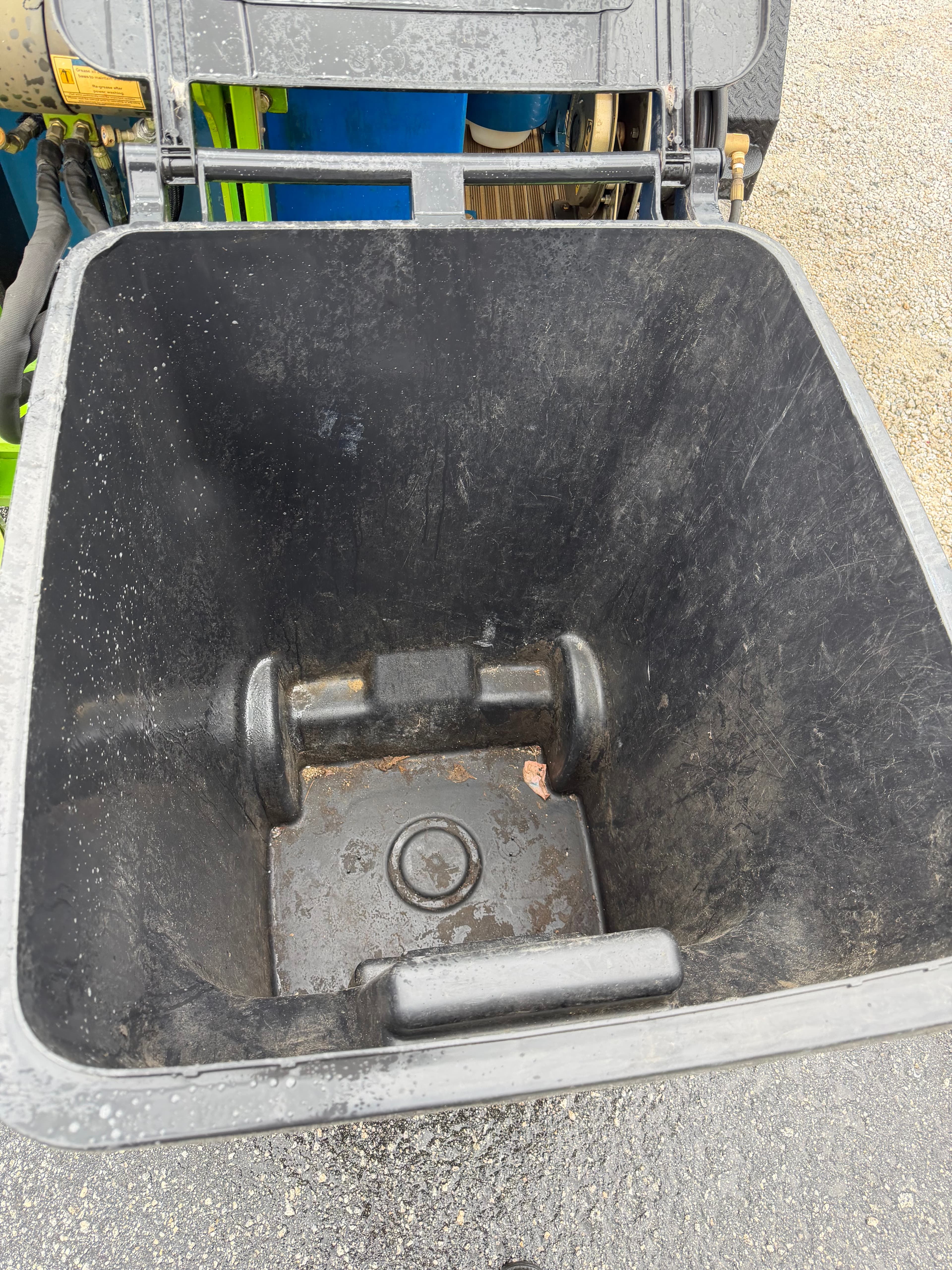 Residue and grime inside an unclean trash bin